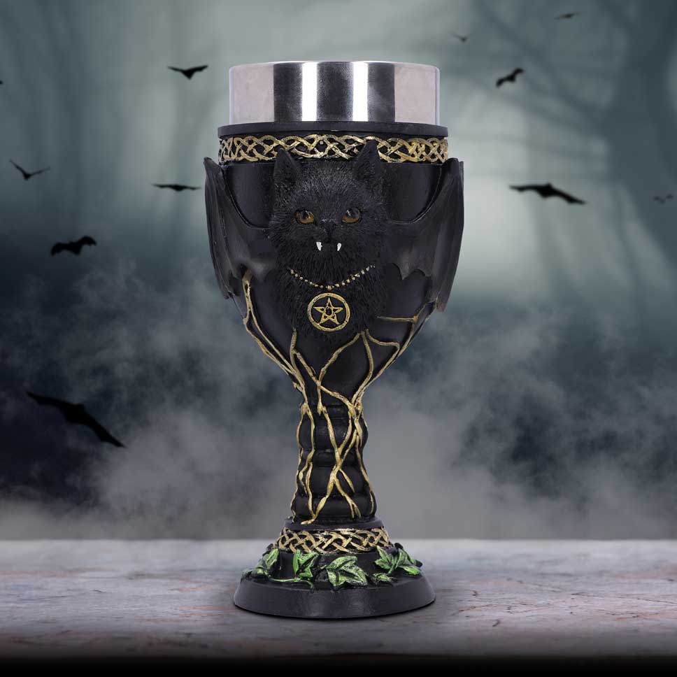 A black goblet with gold details and a green ivy design at the base, featuring a stylized bat and cat silhouette in the center on display