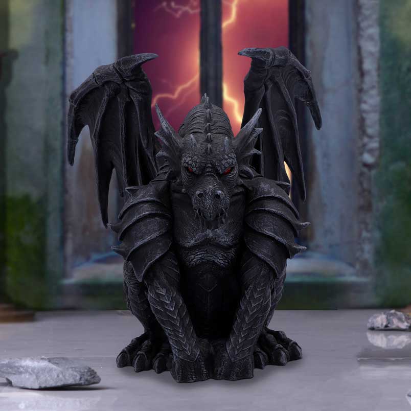 A black figurine of a gothic dragon-like creature with wings and a fierce expression, standing in a crouched position on display