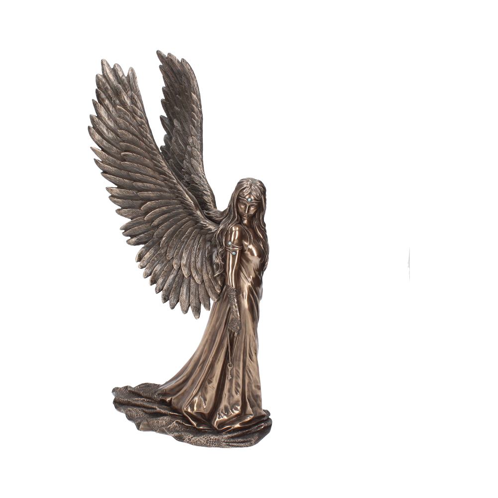 Angel holding symbolic key figurine