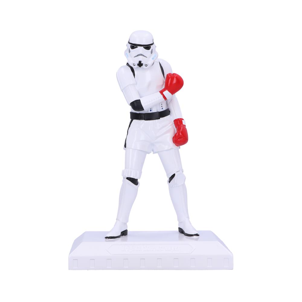 A figurine of a Stormtrooper from Star Wars wearing white clothing and red boxing gloves, posed as if ready to fight.
