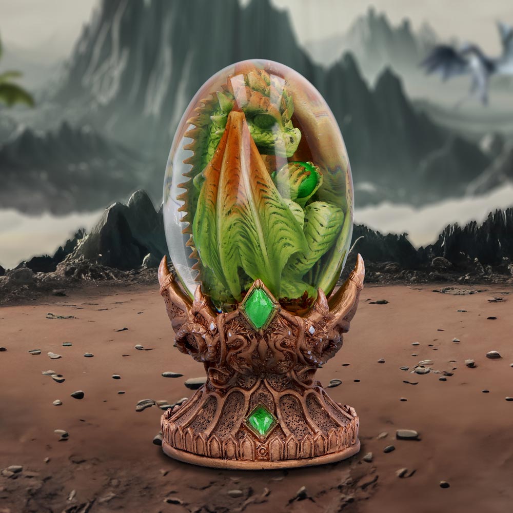 Decorative egg with a dragon design on a ornate stand, dragon collectible on display