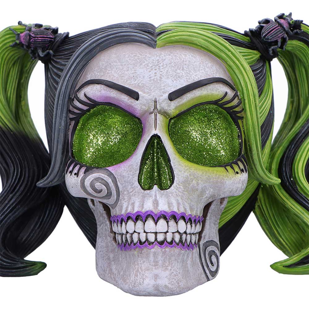 Skull with green eyes, black and green hair, and purple accents