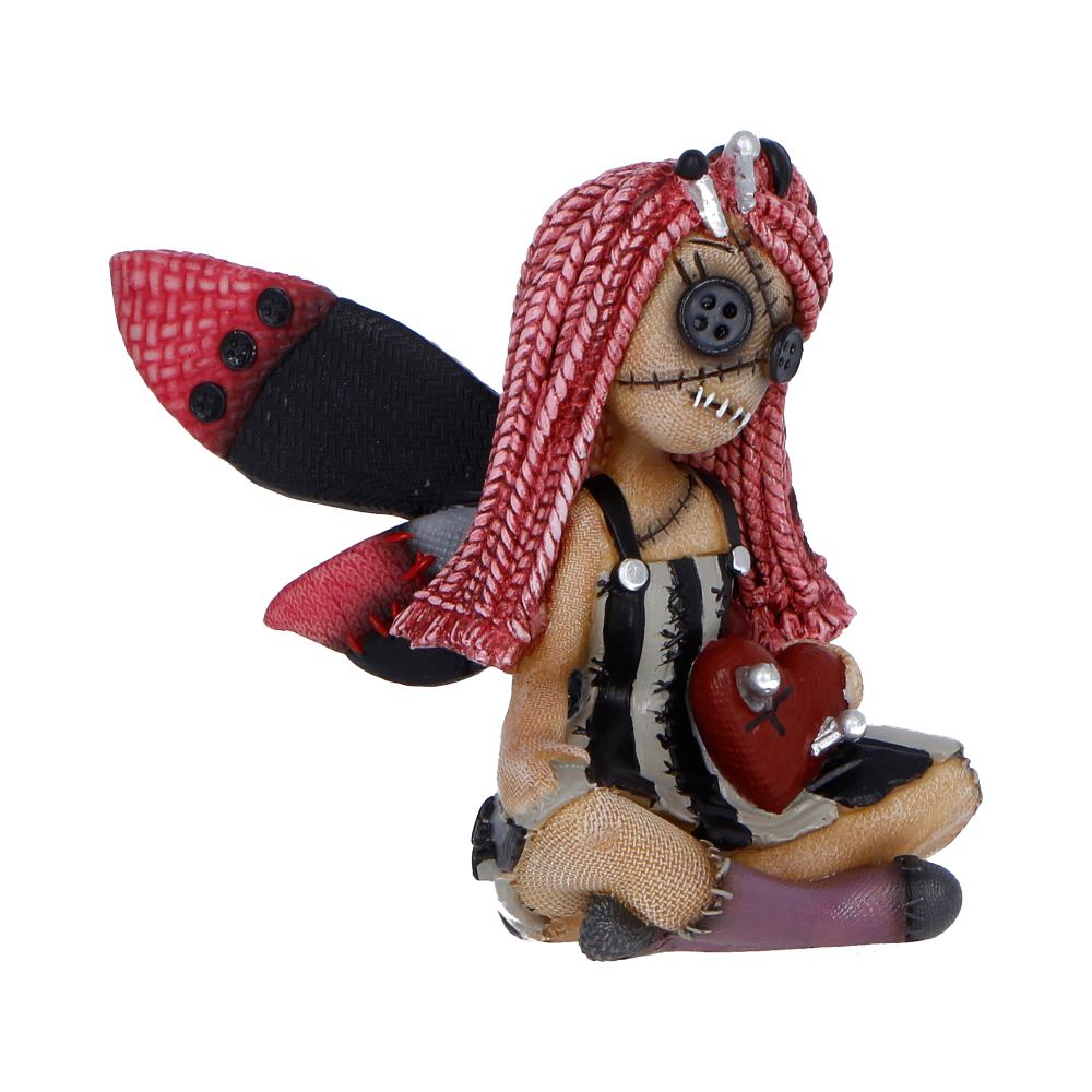 Cute spooky figurine holding heart with pins