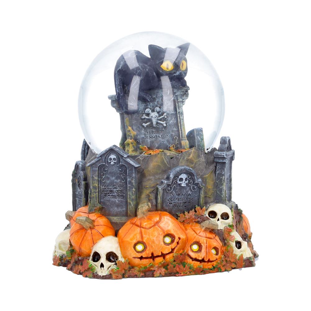 Front view of Pumpkin Patch Halloween cat snow globe with pumpkins and gravestones