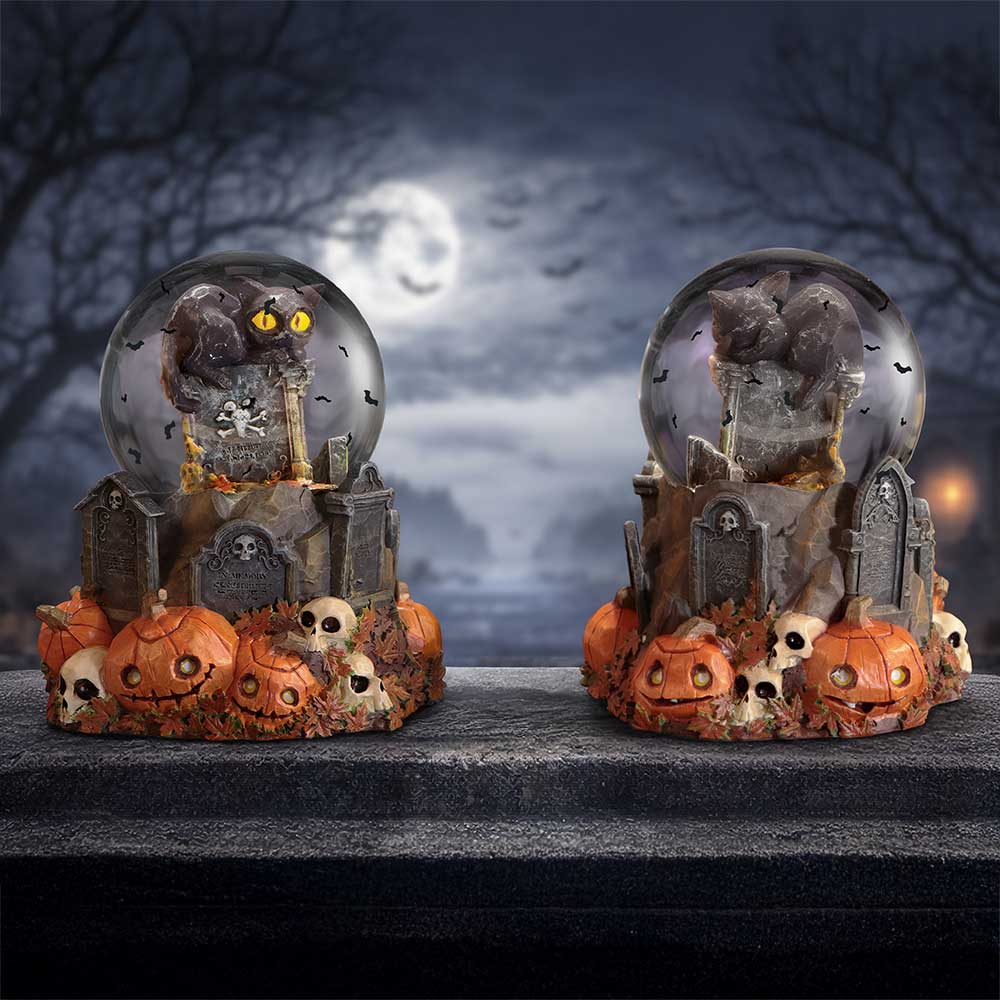 Intricate hand-painted details on Pumpkin Patch Halloween snow globe containing black cat and Halloween scene