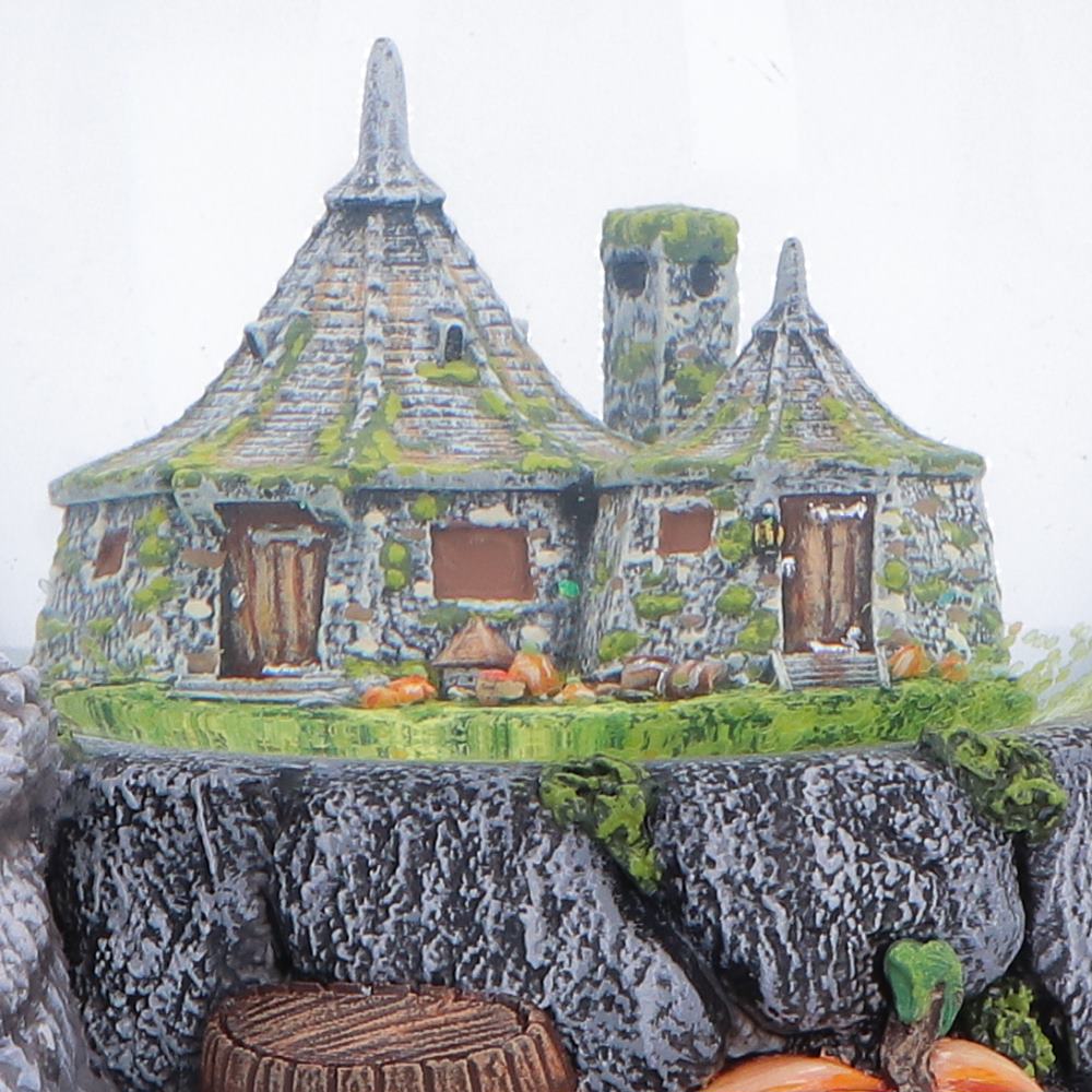 Close-up of the hand-painted miniature Hagrid’s Hut inside the Harry Potter snow globe