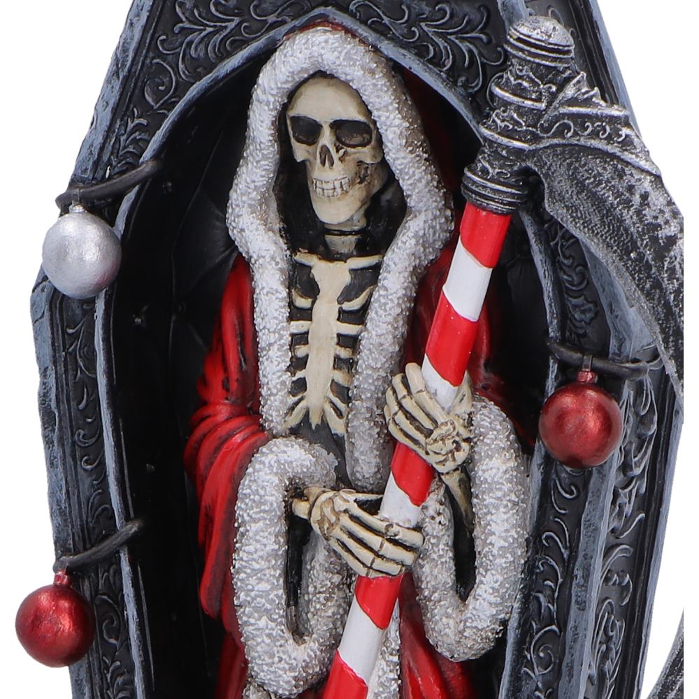 Decorative skeleton figure with a red and white striped pole and Christmas ornaments alternative Christmas gothic decoration