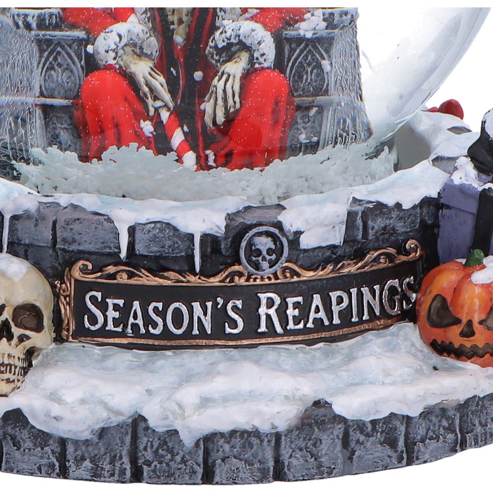 Decorative Halloween scene with skeletons, a sign reading 'Season's Reapings', and a pumpkin.