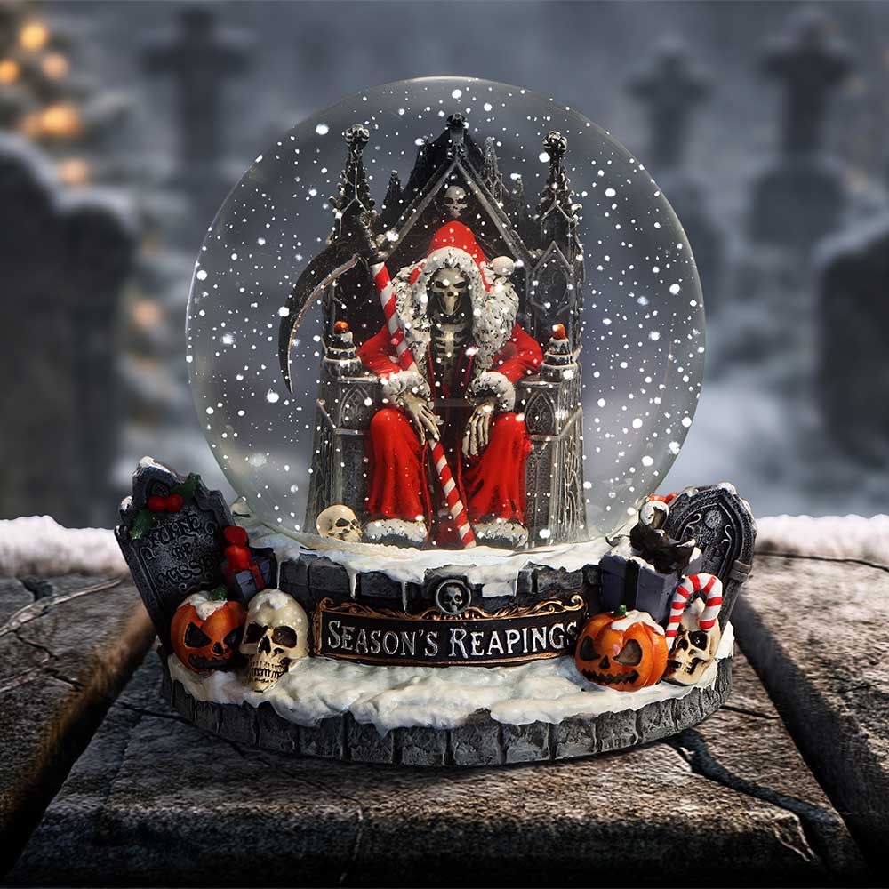 Halloween-themed snow globe with a skeleton in a red robe and candy cane, surrounded by pumpkins and skulls on dislay