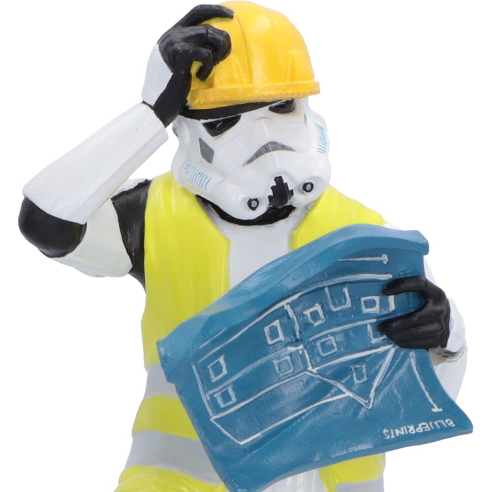 Close up of Original Stormtrooper construction worker figurine with puzzled expression wearing a hard hat and a high-visibility construction jacket with upside-down blueprints.