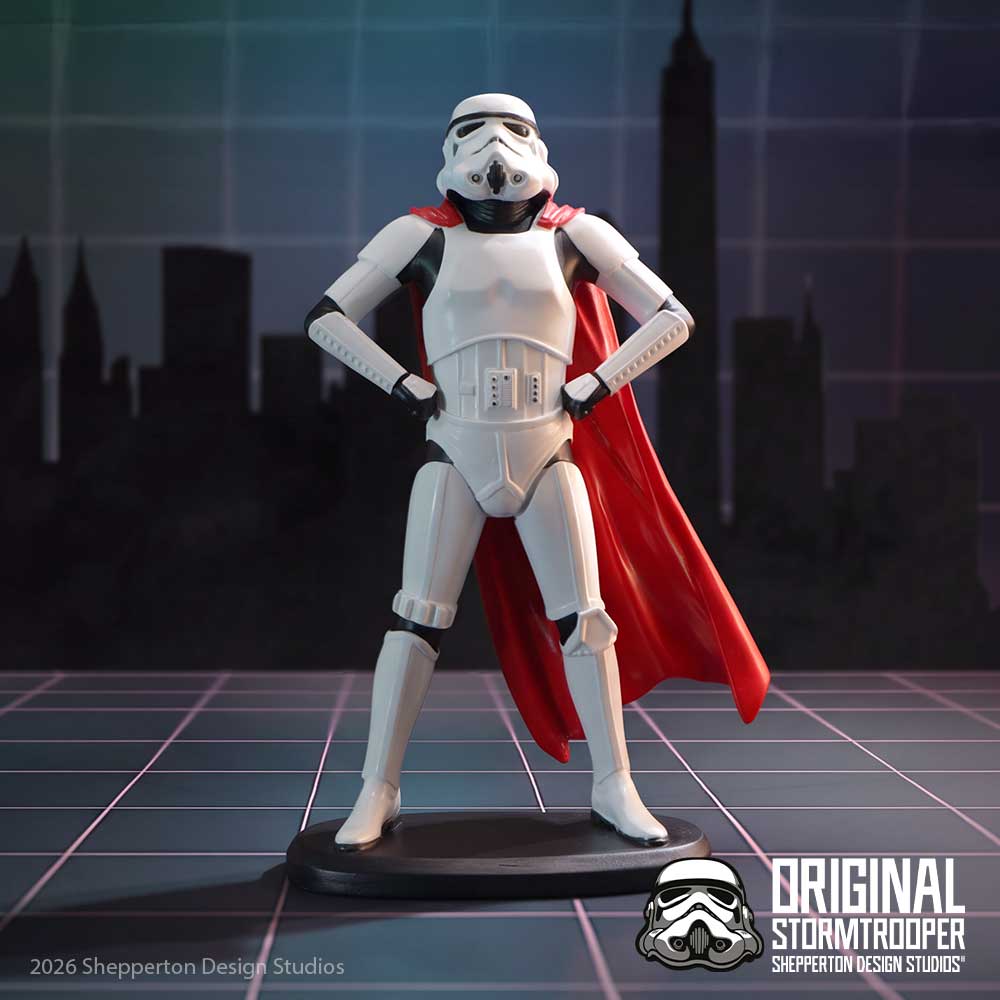 A collectible figure of Original Stormtrooper Super Trooper standing with hands on hips, wearing a flowing red cape and posed on a black base on display.