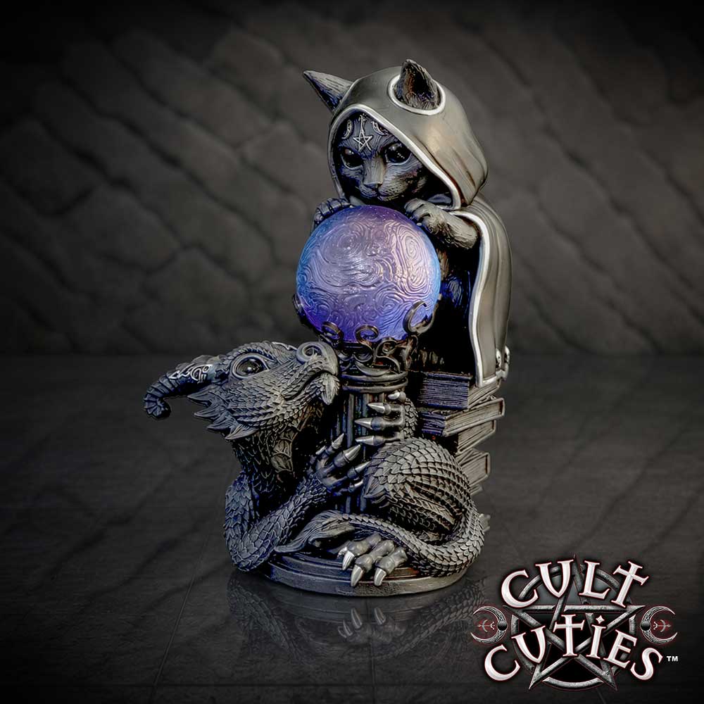 Cult Cuties Mystic Mischief 15.1cm a gothic figurine featuring a black cat in a hooded robe perched on stack of spell books, holding a blue crystal ball, with a black dragon curled around the base on display