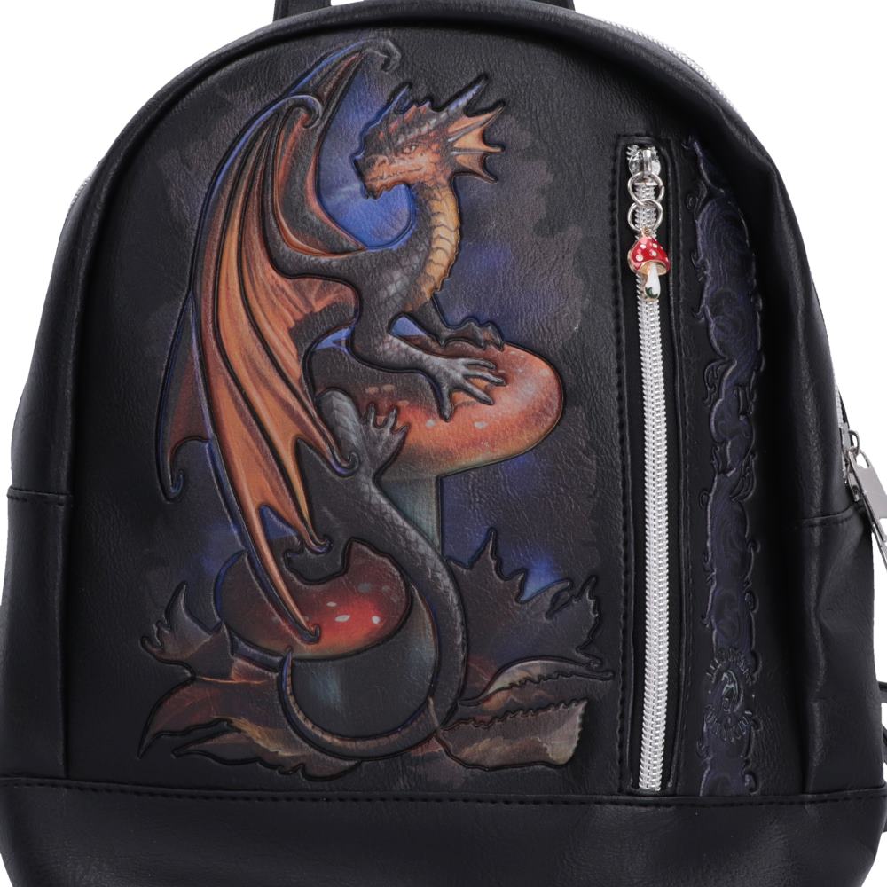 Close-up of black and orange dragon perched on mushrooms