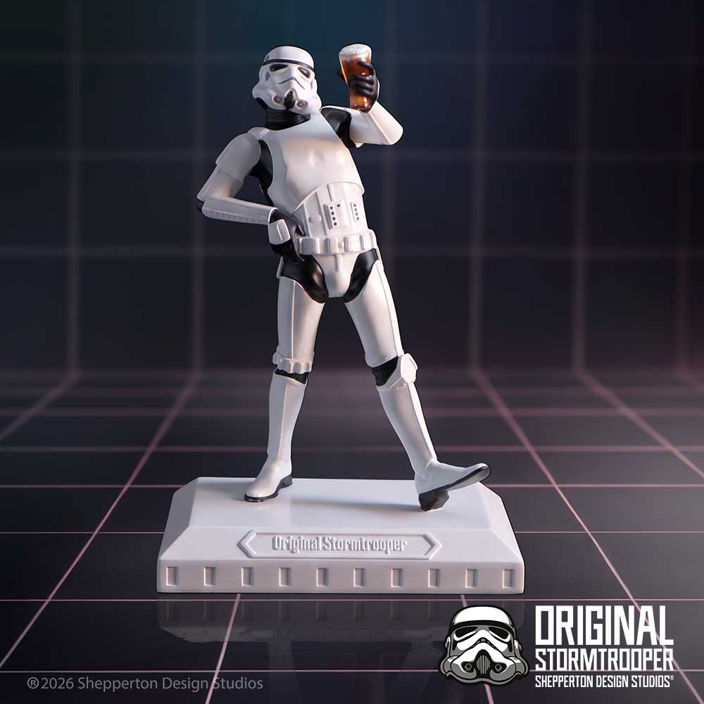 A collectible figurine of an Original Stormtrooper Raise a Glass figurine from Star Wars, posed holding a pint of beer on a matching base. The figure is white with black accents on display.
