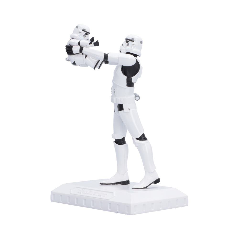 Side view of Original Stormtrooper Who's the Daddy? Star Wars collectible figure of a Stormtrooper holding a small trooper, standing on a white display base.