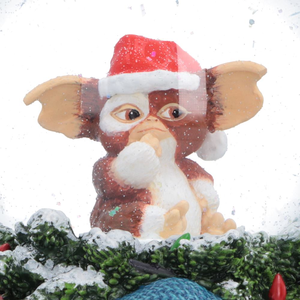 Close-up of Gizmo wearing a Santa hat inside the Gremlins Christmas snow globe