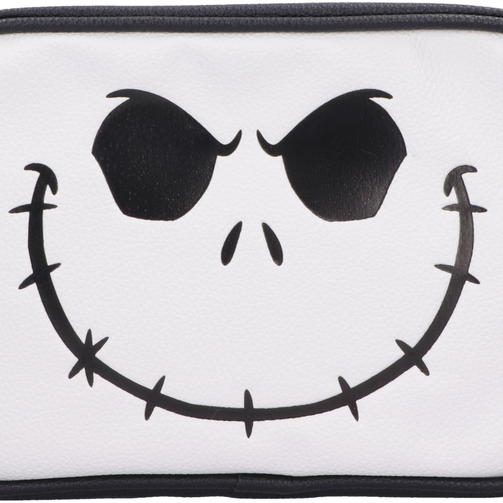 A close-up of a white faux leather bag, featuring a black graphic of Jack Skellington's face with stitched smile and sharp eyes.