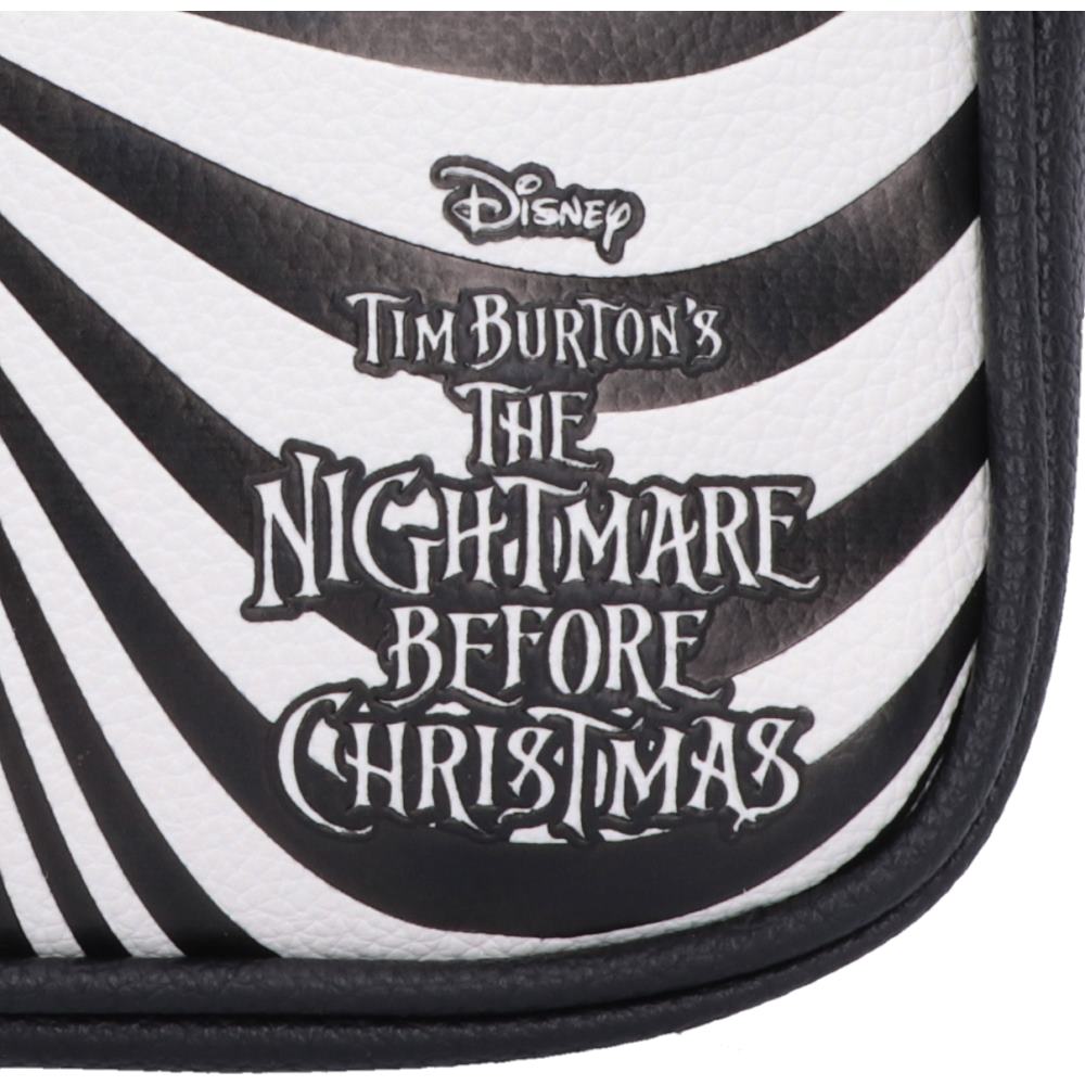 Close-up of a Disney Tim Burton's The Nightmare Before Christmas product featuring a black and white zebra-stripe pattern with the official logo and title text.