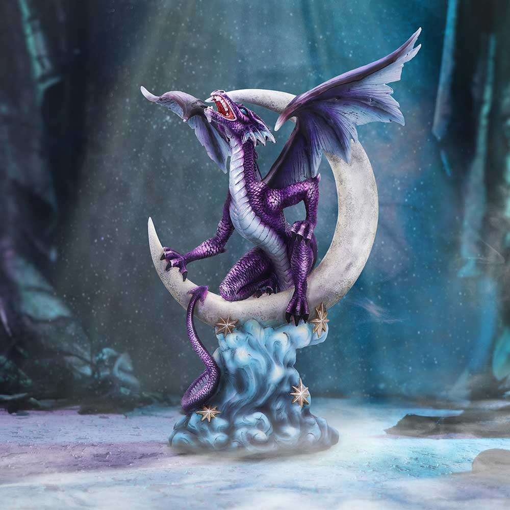 A purple and gray dragon figurine sitting atop a crescent moon, hand-painted and made from resin on display