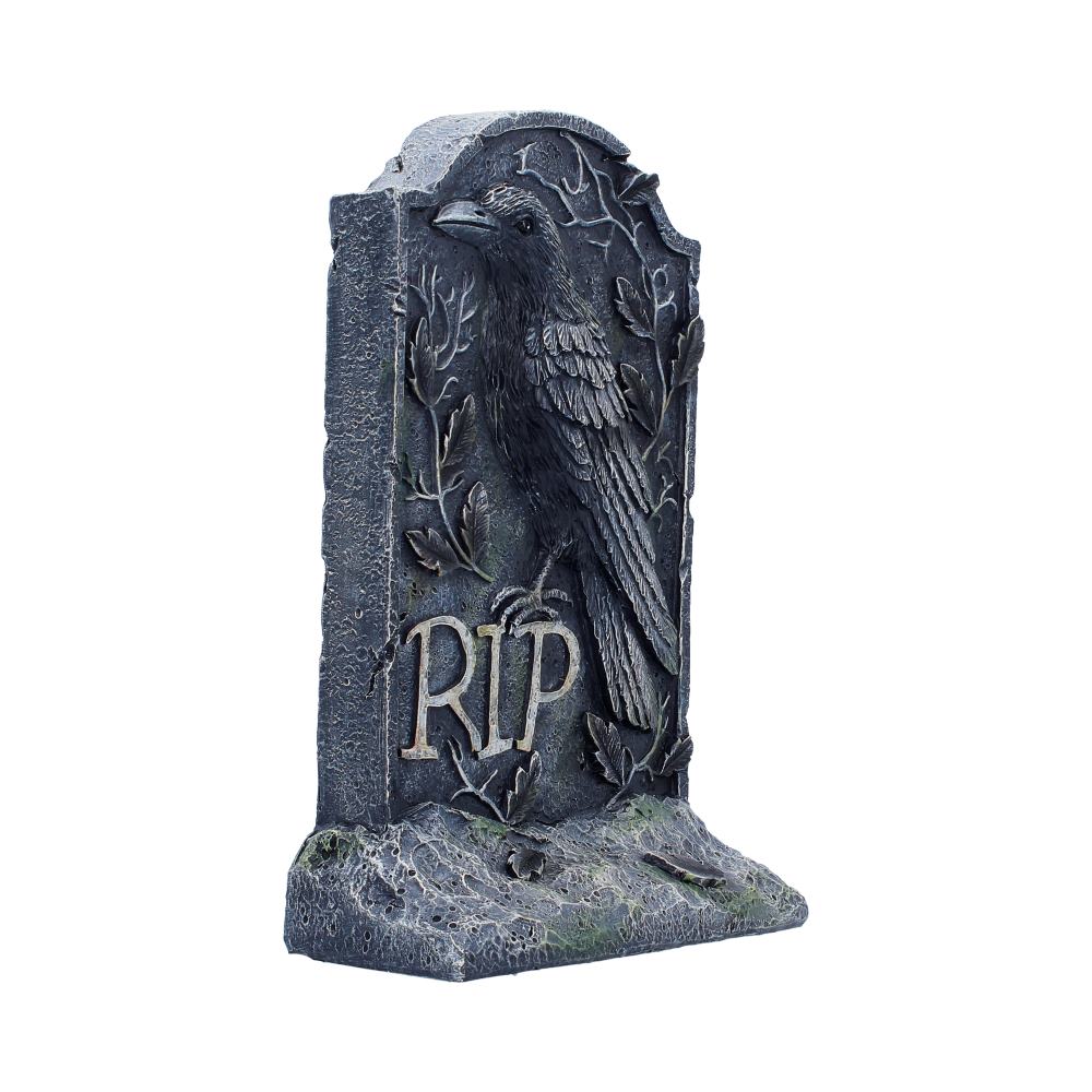 Weathered gravestone ornament with embossed raven and 'RIP' inscription 