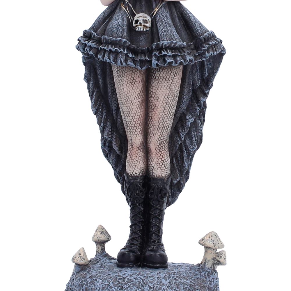 Second Sight fairy in dark clothing with ruffles and fishnet stockings, standing on a rocky surface.