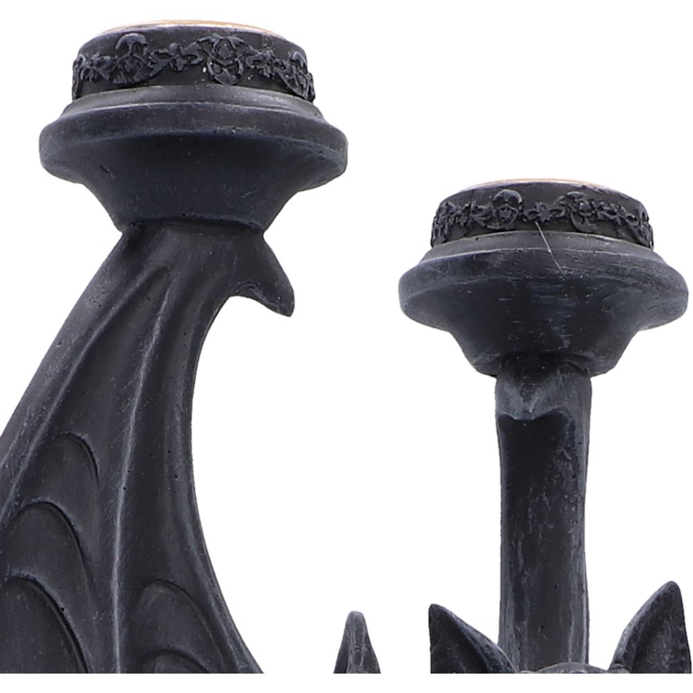 Three candle holders supported by the sculpted bat design