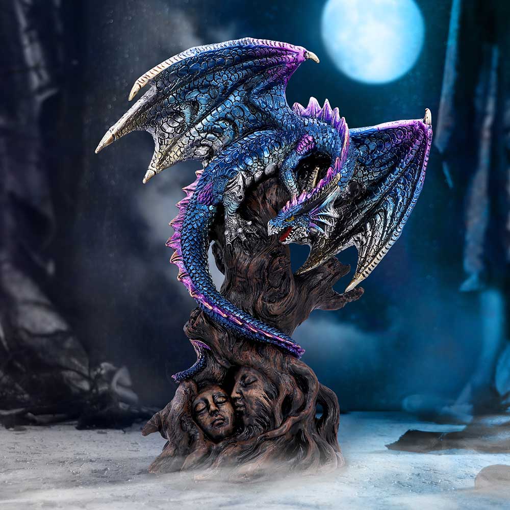 A figurine of a metallic blue dragon perched on top of an ancient tree trunk, with a curved tail and claws on display