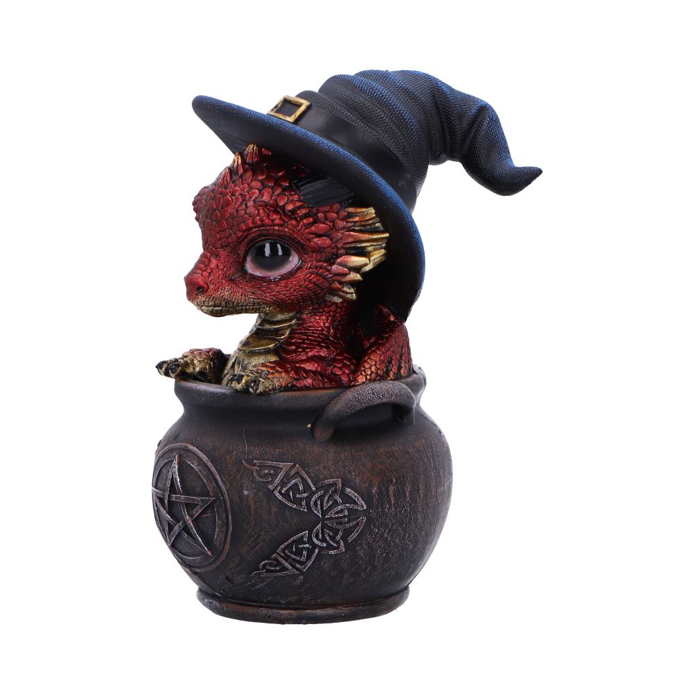 Side view of Spell Scale Dragon figurine wearing a witch hat inside a cauldron with a pentagram design 