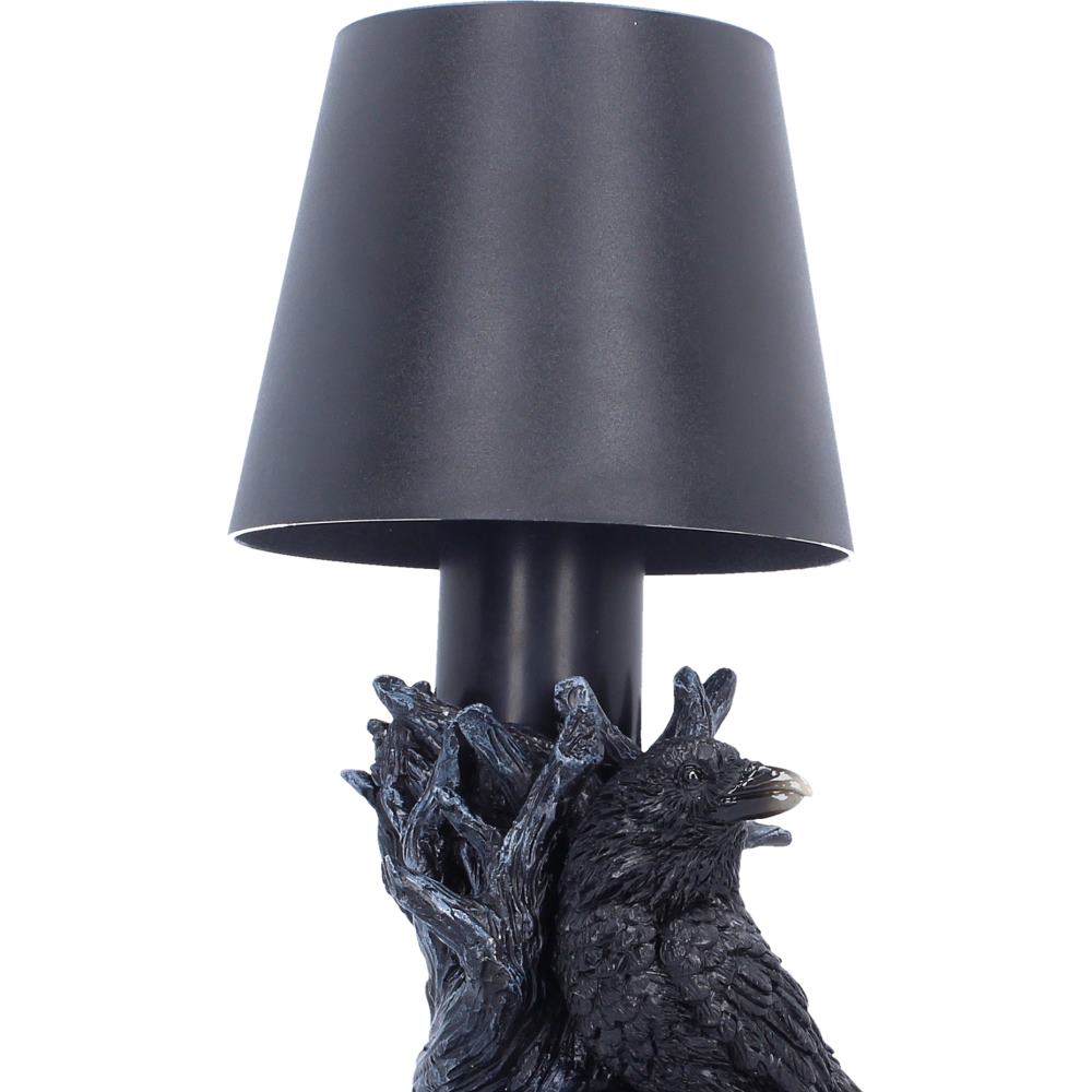 Table lamp with black shade and raven with twisted branches