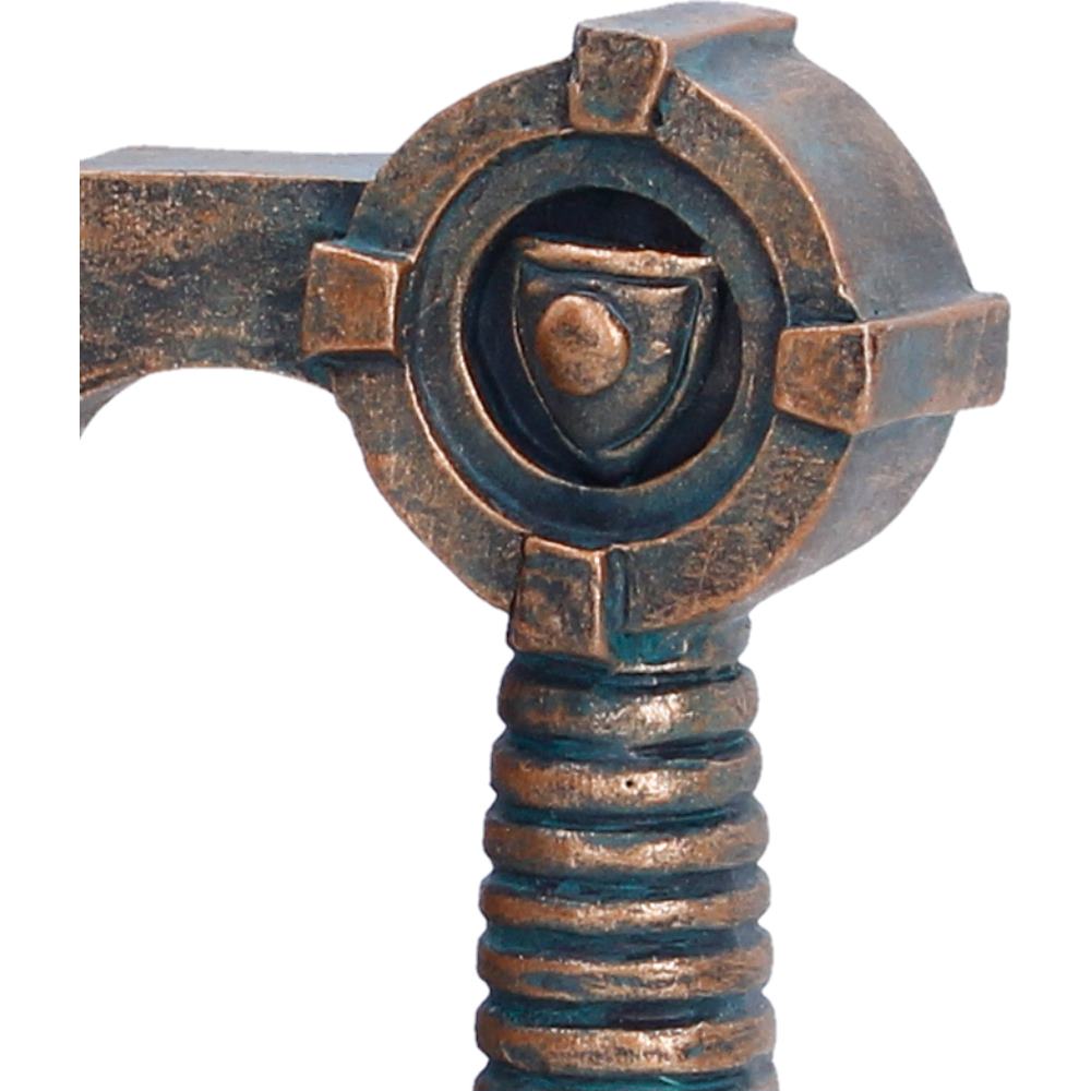 Decorative Viking tankard handle design with bronze hammer and a shield emblem