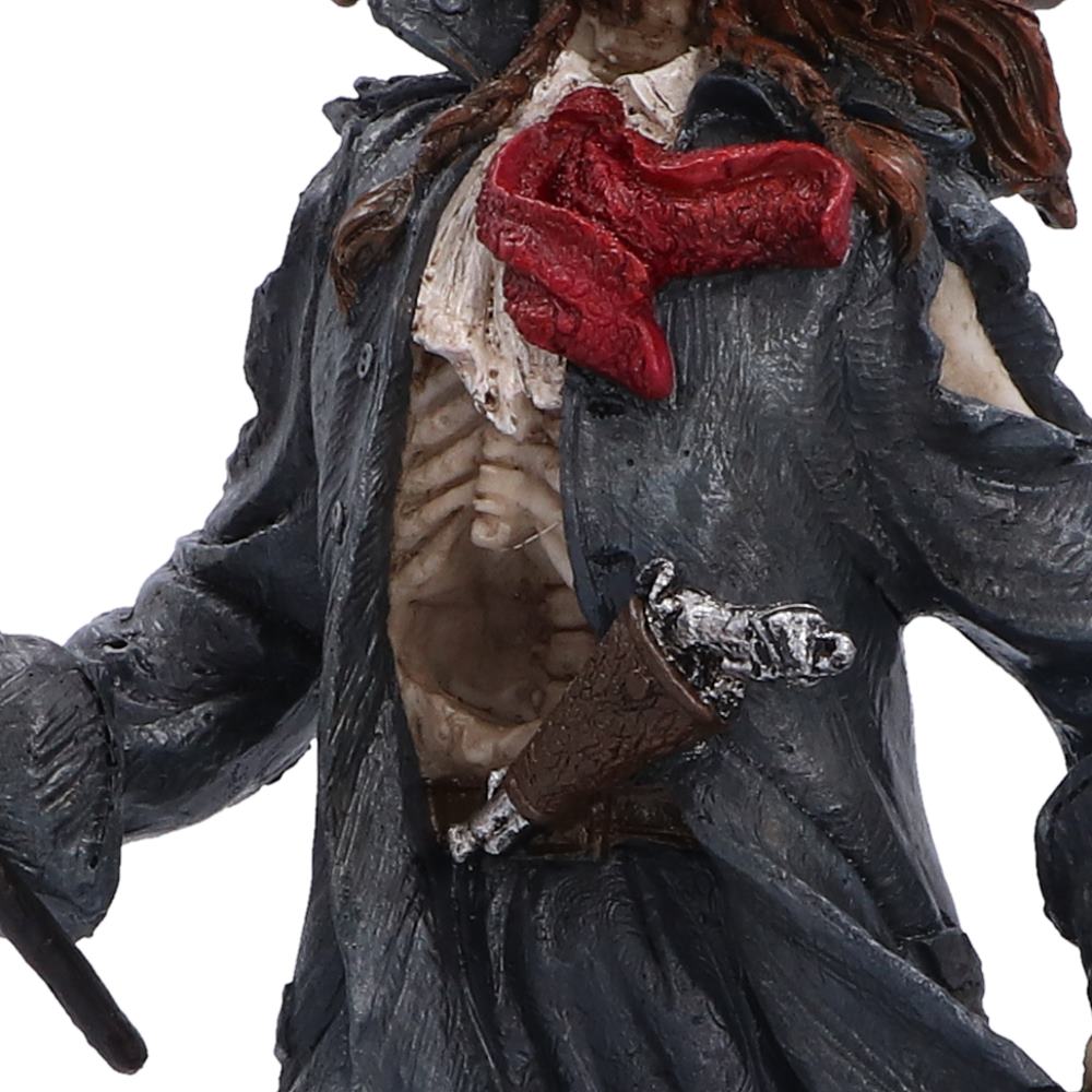A close-up of a pirate figurine or collectible character wearing a dark coat, white shirt, and a bloody red neck scarf, with a silver pistol in the waistband