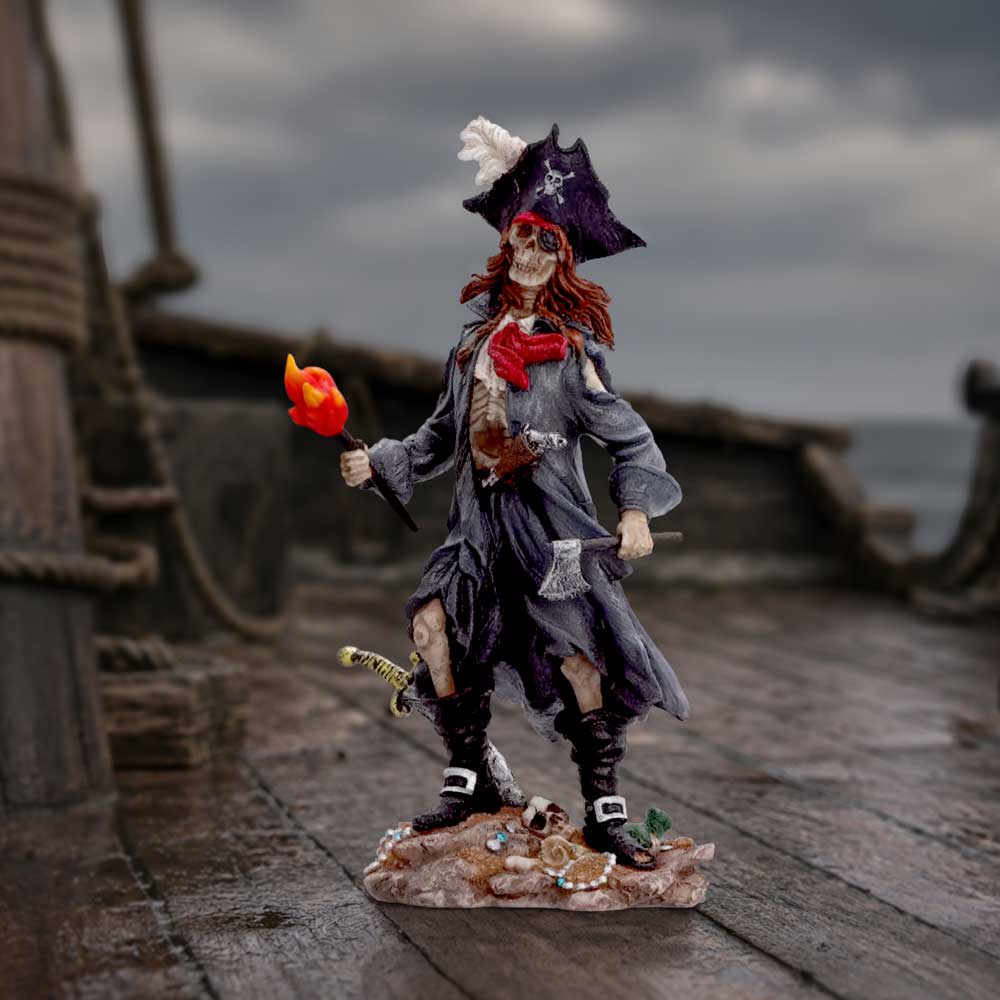 Cursed Captain a detailed pirate figurine standing on a wooden ship deck, holding a flaming torch. The figurine features a skeleton face with red hair, a black pirate hat with a white feather, a tattered gray coat, and black boots gothic skeletal pirate figurine for collectors on display