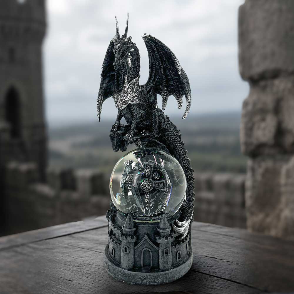 Dragon’s Dominion Snow Globe displayed as a Gothic fantasy collectible. A black dragon figurine with spread wings perched atop a clear glass snow globe, set on a gray castle-style base. 