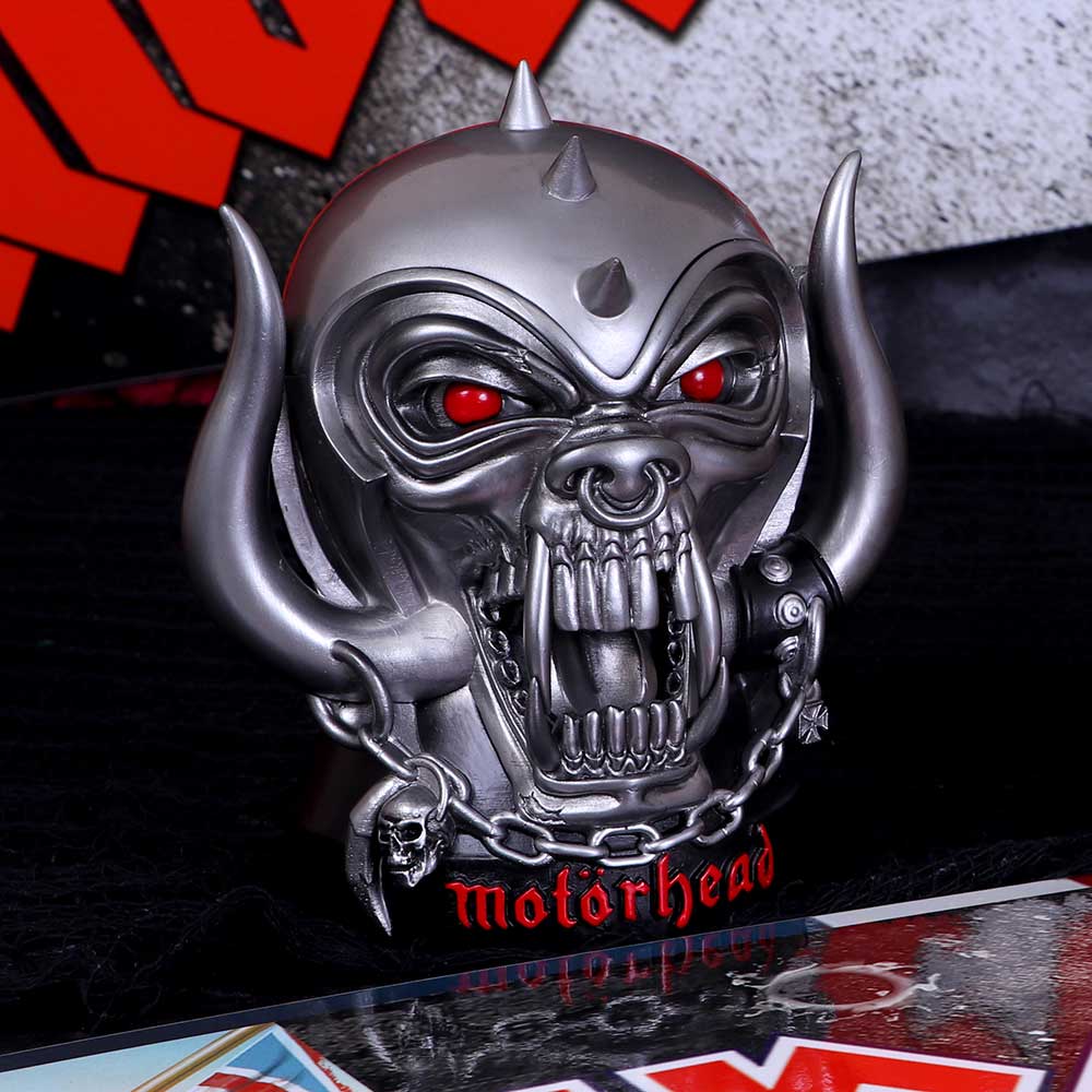 A resin figurine of the Motorhead Warpig with a spiked helmet and red eyes, featuring the band's logo on display