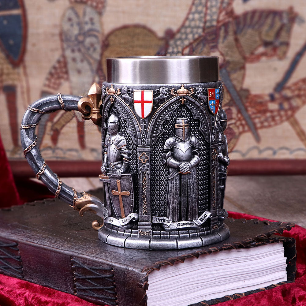 A tankard featuring intricate hand-painted designs of English armoured knights in black and silver colors with ornate arches and a golden chain on the handle on display